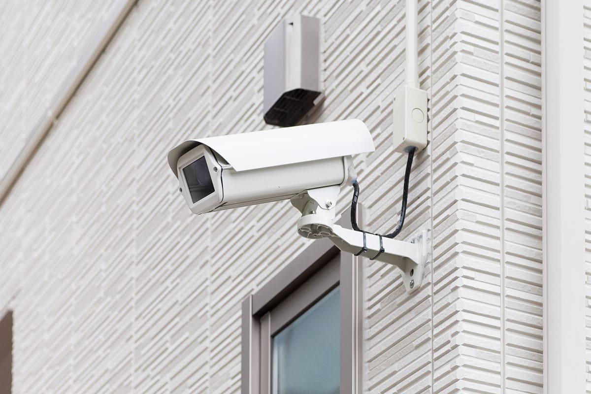 Light Exterior Of Building With Large Security Camera