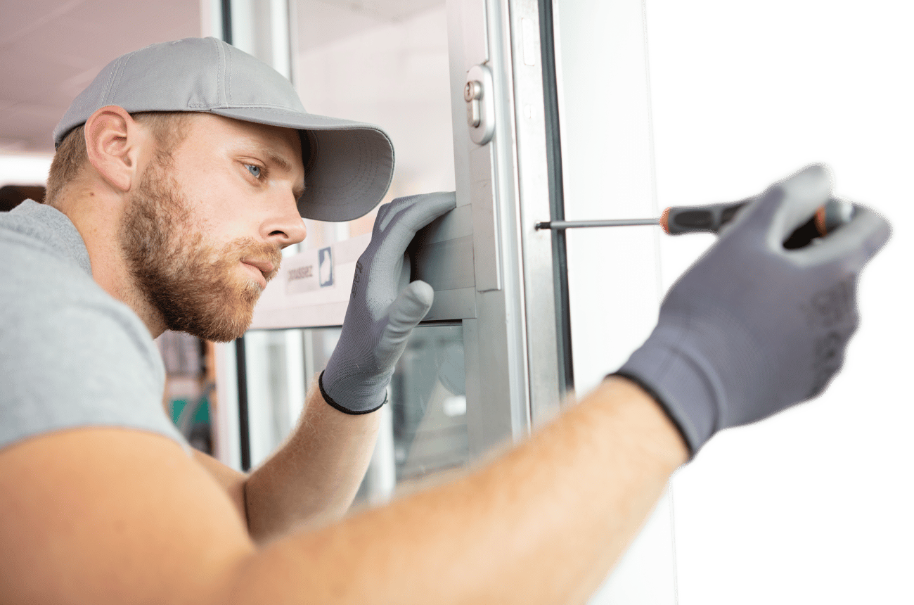 Male With Screwdriver Installing Door Hardware